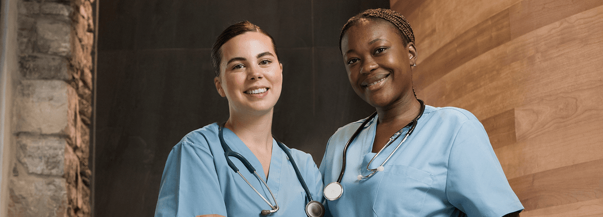 Two smiling caregivers